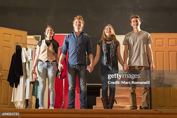 students holding hands on stage - theater actress stock pictures, royalty-free photos & images