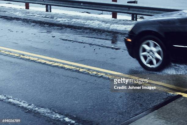 car on road at winter - slushy stock-fotos und bilder