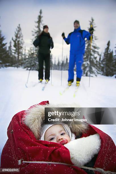 couple skiing with baby - baby ski stock-fotos und bilder