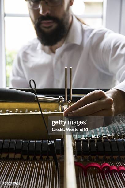 piano tuner tuning grand piano - tuning stock pictures, royalty-free photos & images