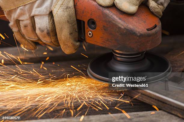 close-up of man grinding - arbeitshandschuhe stock-fotos und bilder