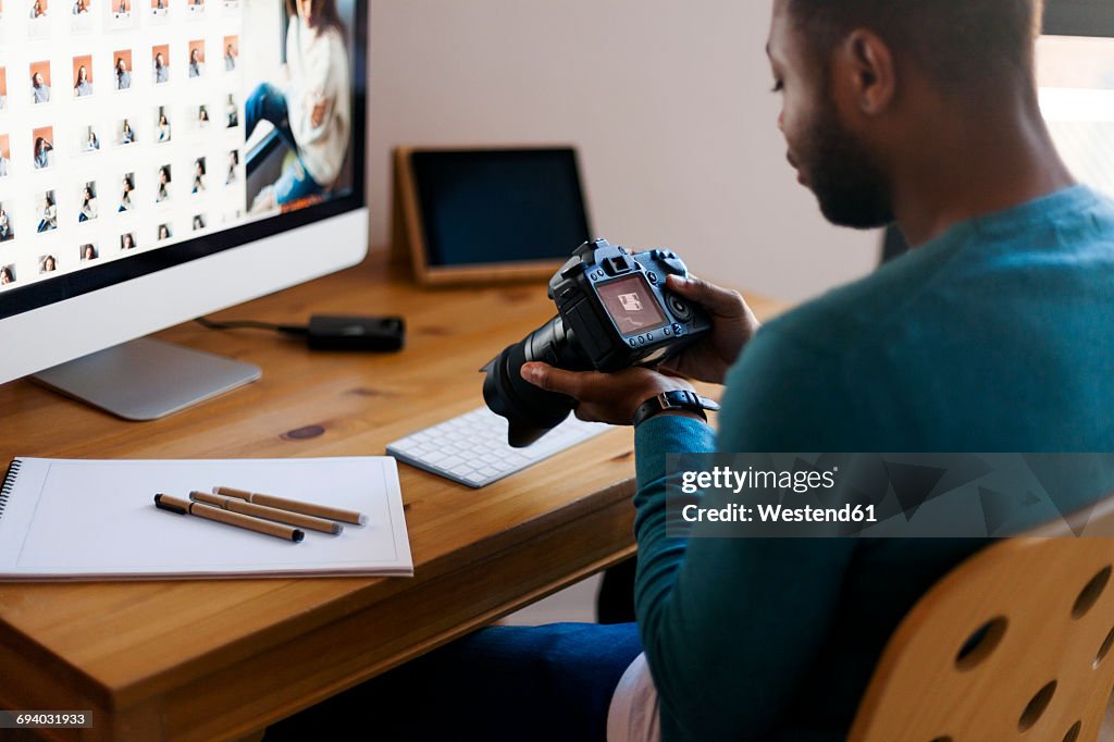 Young photographer editing images at desk
