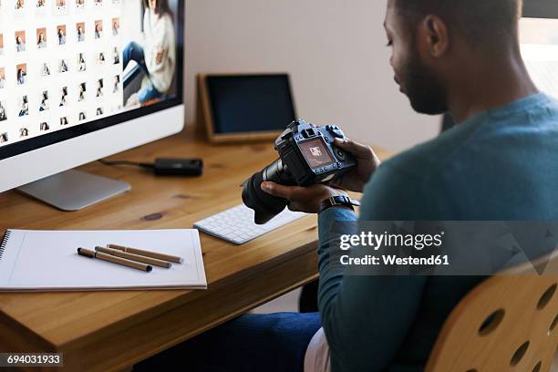 Young photographer editing images at desk