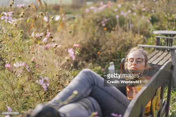 young woman using tablet in cottage garden - garden ipad stock pictures, royalty-free photos & images
