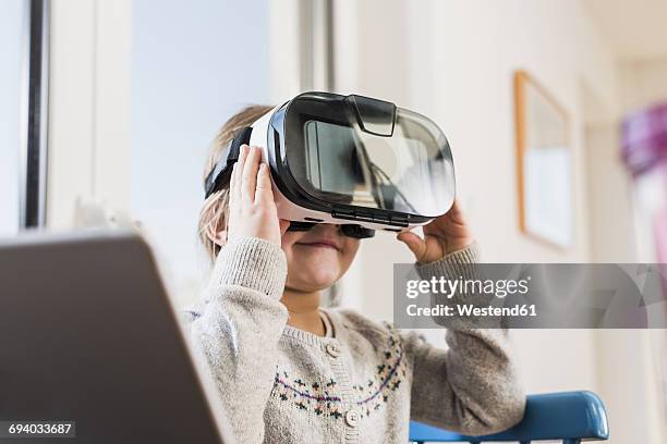 little girl using vr glasses - vr kids stock pictures, royalty-free photos & images