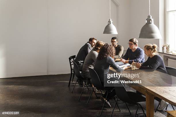 coworkers having a meeting in modern office - economic community stock pictures, royalty-free photos & images