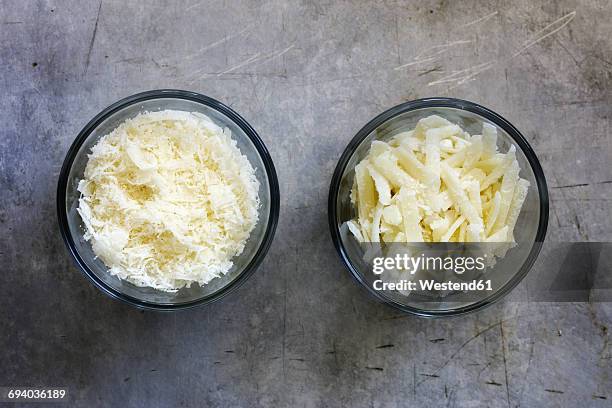 different grated parmesan in glass bowls - parmesan fotografías e imágenes de stock
