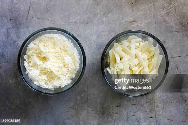 different grated parmesan in glass bowls - grated metal stock pictures, royalty-free photos & images