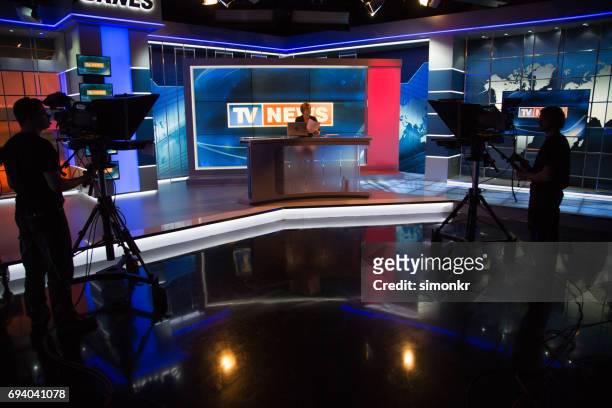 newsreader filming in press room - newscaster stock pictures, royalty-free photos & images