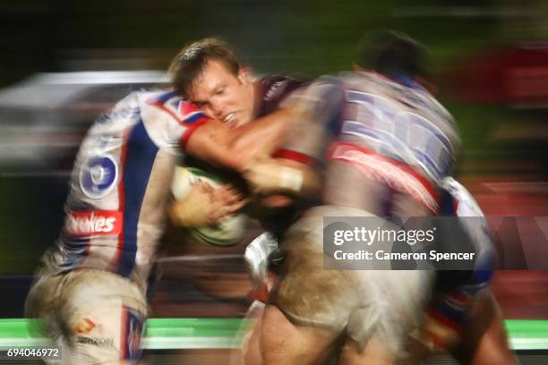 Jake Trbojevic of the Sea Eagles is tackled during the round 14 NRL match between the Manly Sea Eagles and the Newcastle Knights at Lottoland on June...