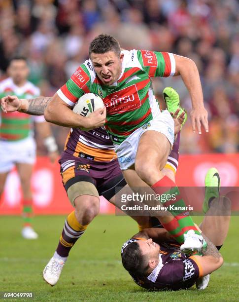 Sam Burgess of the Rabbitohs breaks through the defence during the round 14 NRL match between the Brisbane Broncos and the South Sydney Rabbitohs at...