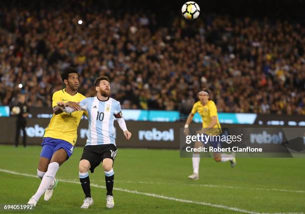 Lionel Messi of Argentina is challenged by Gil SIlva of Brazil during the Brazil Global Tour match between Brazil and Argentina at Melbourne Cricket...