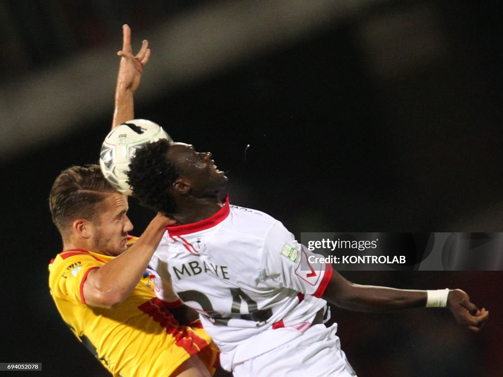 Benevento's Romanian forward George Puscas (L) fights for...