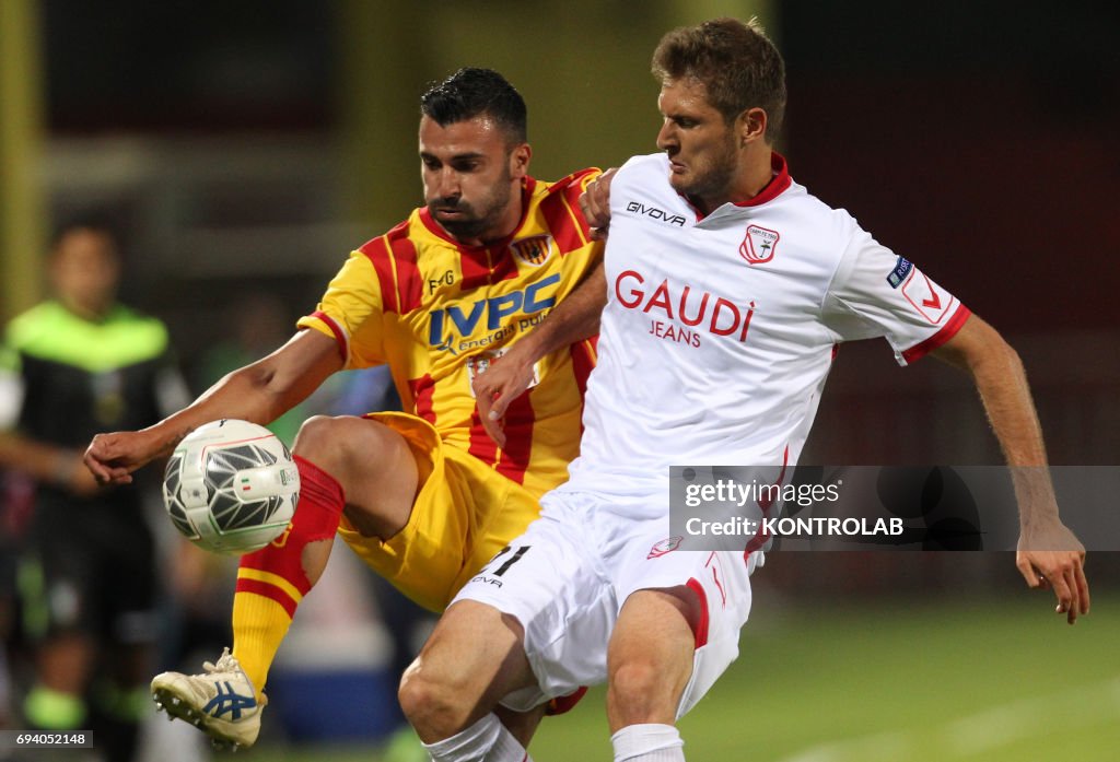 Benevento's Italian forward Fabio Ceravolo fights for the...