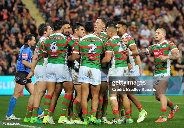 Bryson Goodwin of the Rabbitohs is congratulated by team mates after scoring a try during the round 14 NRL match between the Brisbane Broncos and the...