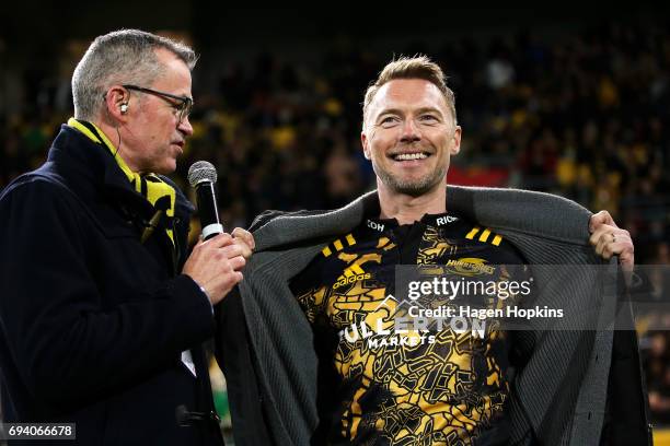 Ronan Keating shows off his Hurricanes tshirt during the round 16 Super Rugby match between the Hurricanes and the Chiefs at Westpac Stadium on June...