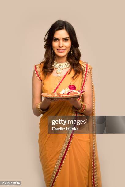 woman holding plate of religious offering - indian wedding dress stock pictures, royalty-free photos & images