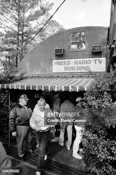 The Pinkerton Guard fondly known as 'Tiny' stands guard outside the Quonset Hut 'Press Building' controlling the media access during the first round...