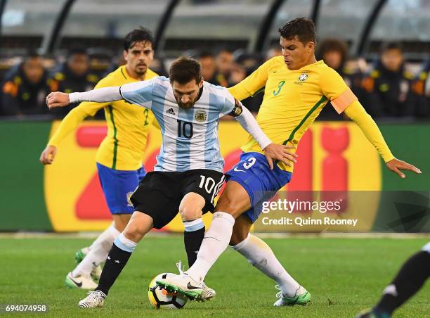 Lionel Messi of Argentina and Thiago Silva of Brazil compete for the ball during the Brazil Global Tour match between Brazil and Argentina at...