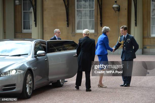 Prime Minister Theresa May with her husband Philip arrives at Buckingham Palace where she will seek the Queen's permission to form a UK government on...