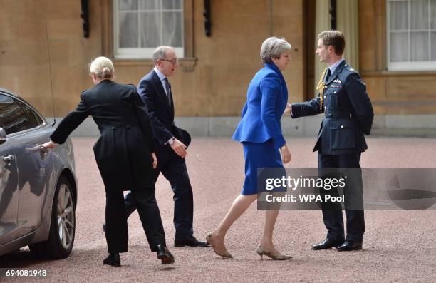 Prime Minister Theresa May with her husband Philip arrives at Buckingham Palace where she will seek the Queen's permission to form a UK government on...