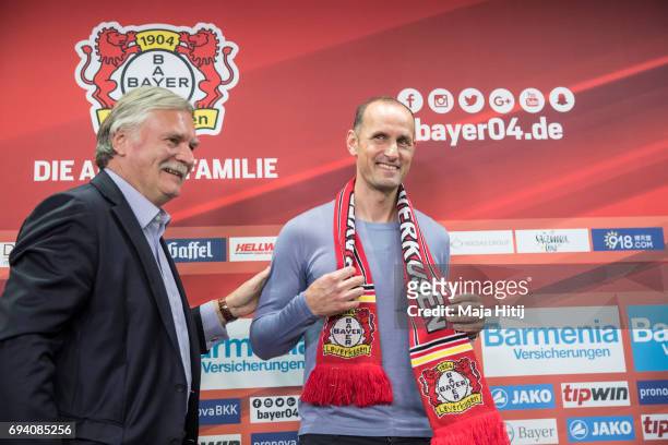 The newly appointed head coach Heiko Herrlich and chairman Michael Schade smile after a press conference at BayArena on June 9, 2017 in Leverkusen,...