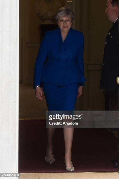 British Prime Minister Theresa May leaves No.10 Downing Street for a meeting with Queen Elizabeth II to seek permission to form a coalition...