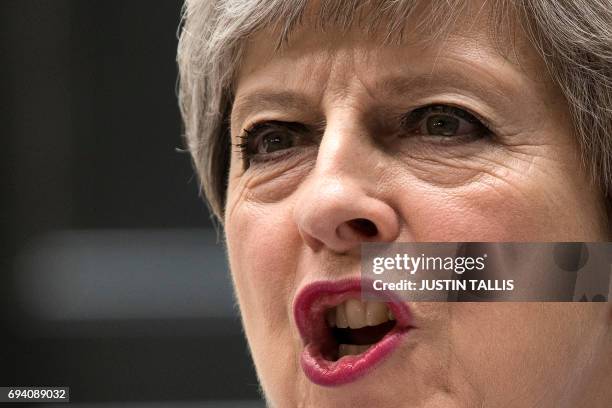 Britain's Prime Minister and leader of the Conservative Party Theresa May, makes a statement outside 10 Downing Street in central London on June 9,...