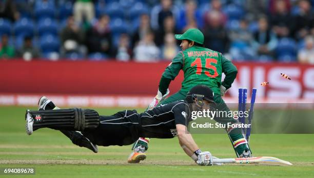 New Zealand batsman Kane Williamson dives to make his ground as wicketkeeper Mushfiqur Rahim removes the bails during the ICC Champions Trophy match...