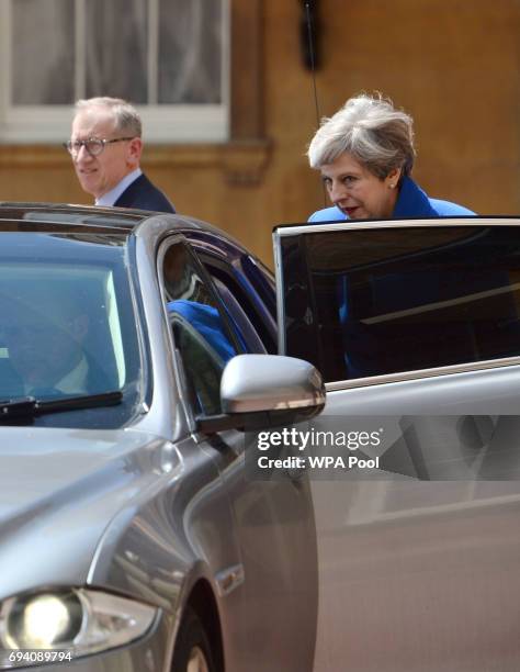 Prime Minister Theresa May with husband Philip leave Buckingham Palace after a meeting with the Queen to seek permission to form a UK government on...