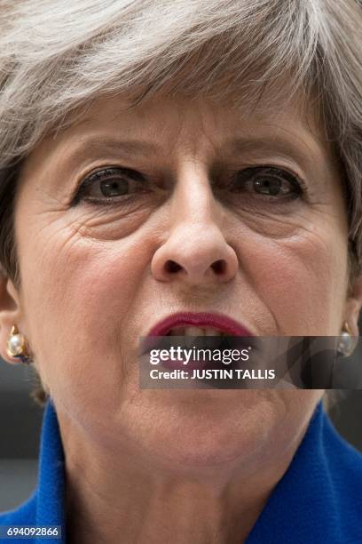 Britain's Prime Minister and leader of the Conservative Party Theresa May delivers a statement outside 10 Downing Street in central London on June 9,...