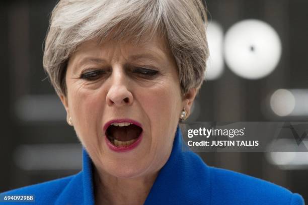 Britain's Prime Minister and leader of the Conservative Party Theresa May delivers a statement outside 10 Downing Street in central London on June 9,...