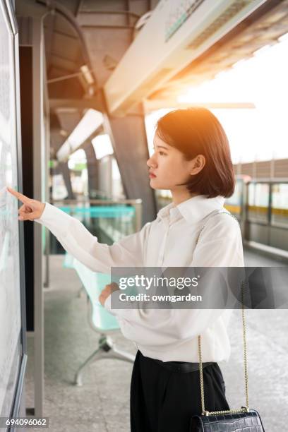 business women watching map in the subway,shanghai,china - looking at subway map stock pictures, royalty-free photos & images