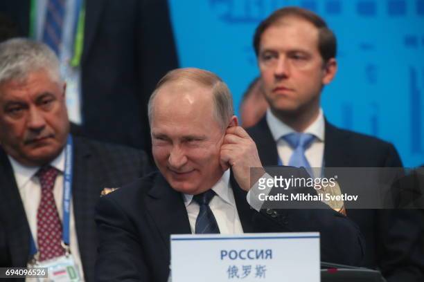 Interior Minister Vladimir Kolokoltsev and Industry and Enegry Minister Denis Manturov look on as Russian President Vladimir Putin is seen during the...