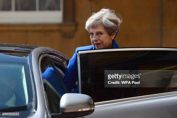 Prime Minister Theresa May with husband Philip leave Buckingham Palace after a meeting with the Queen to seek permission to form a UK government on...