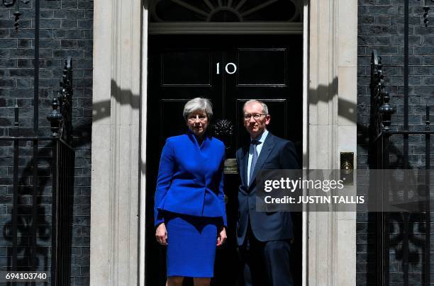 Britain's Prime Minister and leader of the Conservative Party Theresa May, , accompanied by her husband Philip , pose after the prime minister...