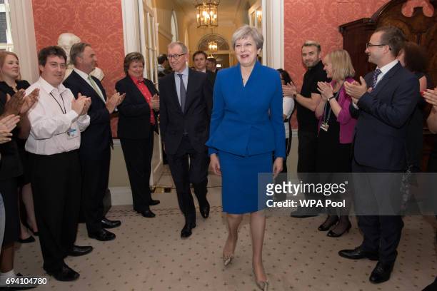 British Prime Minister Theresa May and her husband Philip are clapped into 10 Downing Street in by staff after returning from seeing Queen Elizabeth...