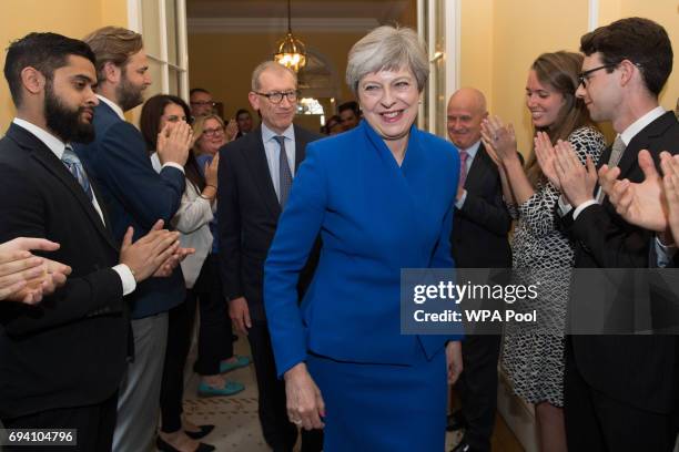 British Prime Minister Theresa May and her husband Philip are clapped into 10 Downing Street in by staff after returning from seeing Queen Elizabeth...