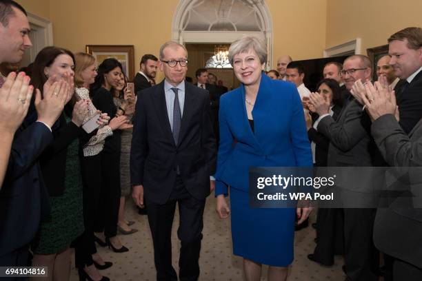 British Prime Minister Theresa May and her husband Philip are clapped into 10 Downing Street in by staff after returning from seeing Queen Elizabeth...