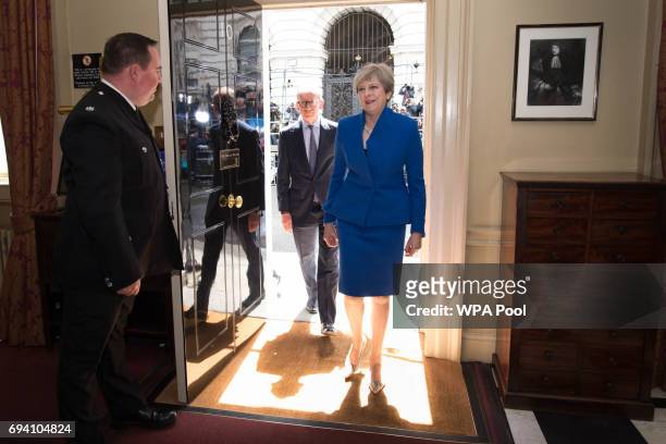 British Prime Minister Theresa May and her husband Philip walk into into 10 Downing Street after returning from seeing Queen Elizabeth II at...