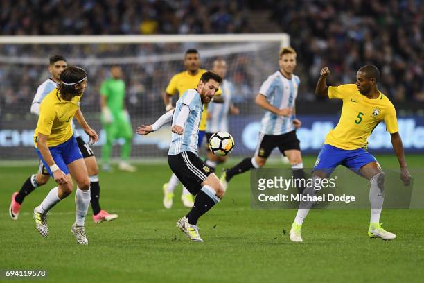 Lionel Messi of Argentina competes for the ball against Fernando Roza of Brazil during the Brasil Global Tour match between Brazil and Argentina at...