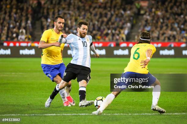 Lionel Messi dribbles with the ball past Renato Augusto as Argentina plays Brazil in the Chevrolet Brasil Global Tour on June 09, 2017 in Melbourne,...