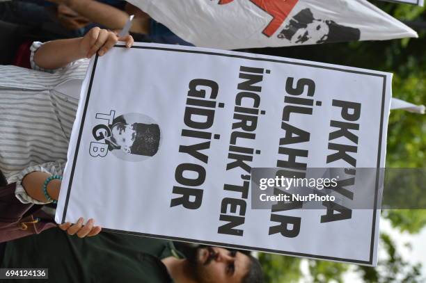 Banner is seen that reads 'Weapons go to PKK through Incirlik' in Turkish during a protest against the U.S. And its army at the Incirlik Air Base in...