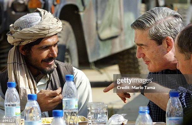 Federal Bureau of Investigation Director Robert Mueller has lunch with Haji Gulali, commander of the Kandahar region, on the American military...