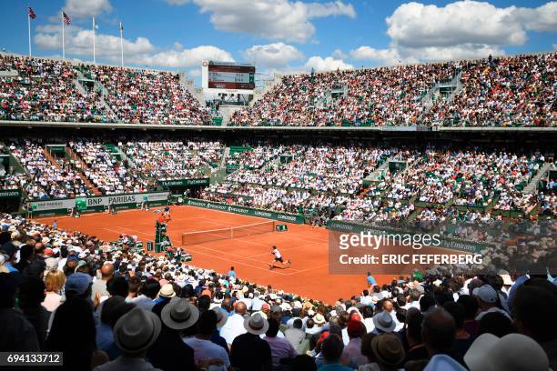 Photo shows a general view of the Philippe Chatrier court as Britain's Andy Murray returns the ball to Switzerland's Stanislas Wawrinka during their...