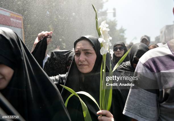Hundreds of people shout slogans during a funeral ceremony held for the victims of the attacks of Irans parliament and the shrine of Ayatollah...