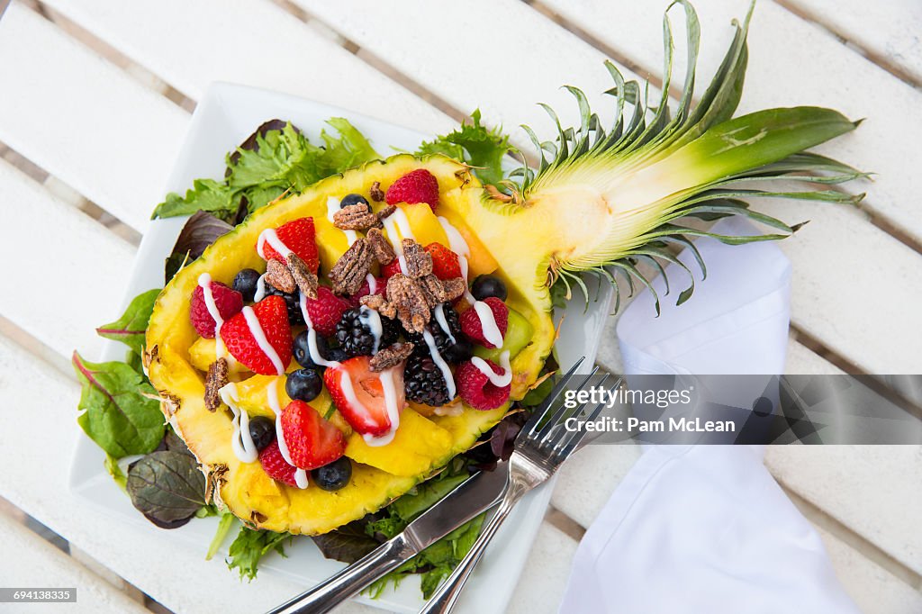 Fruit salad served in a half pineapple