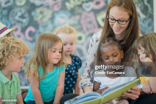 reading to preschoolers - nursery school child stock pictures, royalty-free photos & images