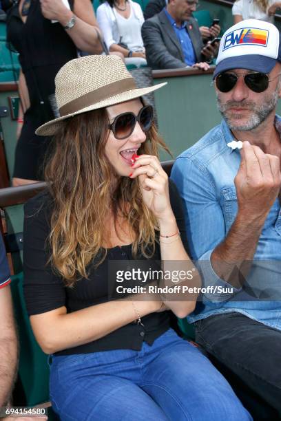 Actress Alice Pol, eating sweets, attends the 2017 French Tennis Open - Day Thirteen at Roland Garros on June 9, 2017 in Paris, France.