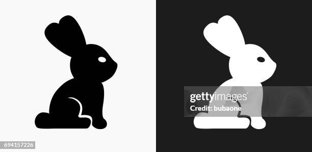 rabbit icon on black and white vector backgrounds - multiple rabbits stock illustrations
